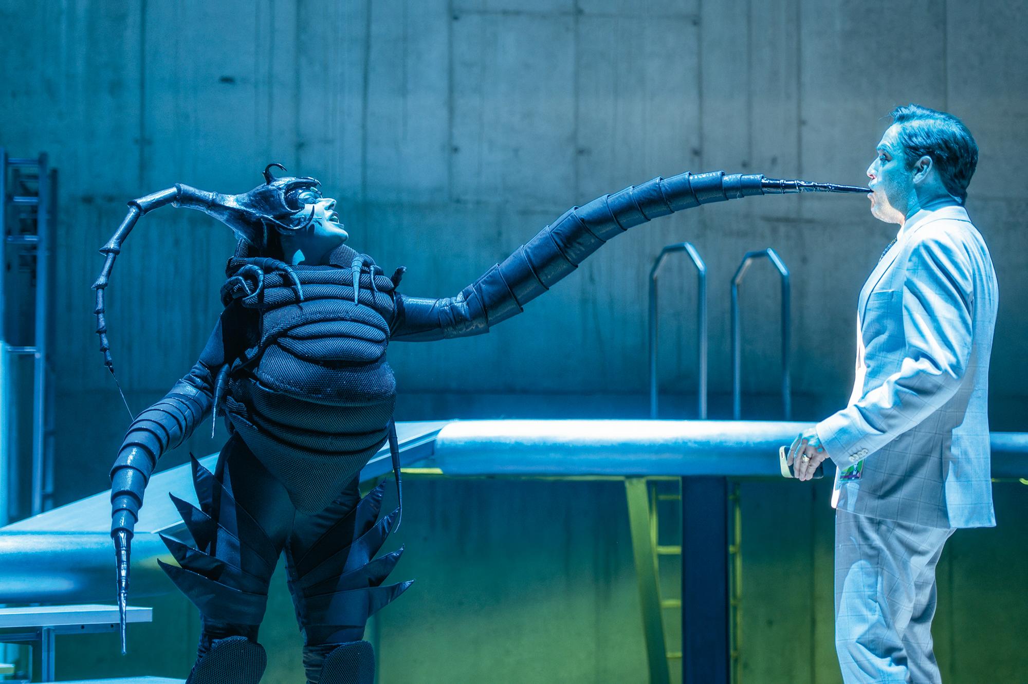 Sarah Maria Grünig und Thomas Prazak in „Deine Arbeit hasst dich, weil sie dich nicht braucht“, Uraufführung von Dietmar Daths neuem Stück am Staatstheater Augsburg, Regie André Bücker, Bühne Robert Schweer, Kostüme Imme Kachel